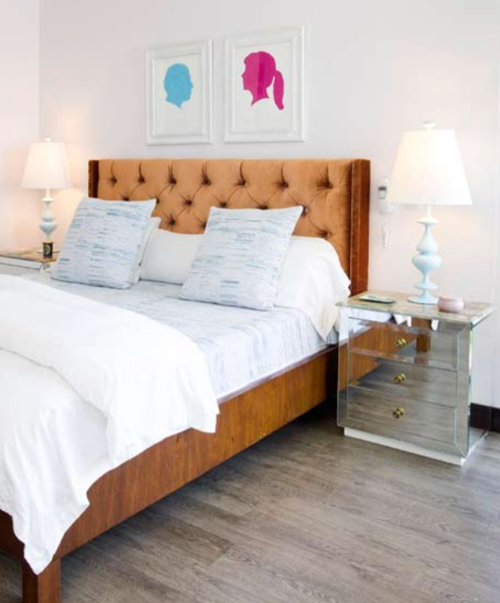 Inspiration for a large eclectic guest bedroom in Miami with white walls and plywood floors.