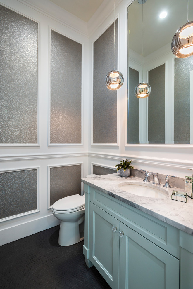 Inspiration for a small traditional powder room in Vancouver with recessed-panel cabinets, blue cabinets, a one-piece toilet, grey walls, mosaic tile floors, an undermount sink, granite benchtops, black floor and grey benchtops.