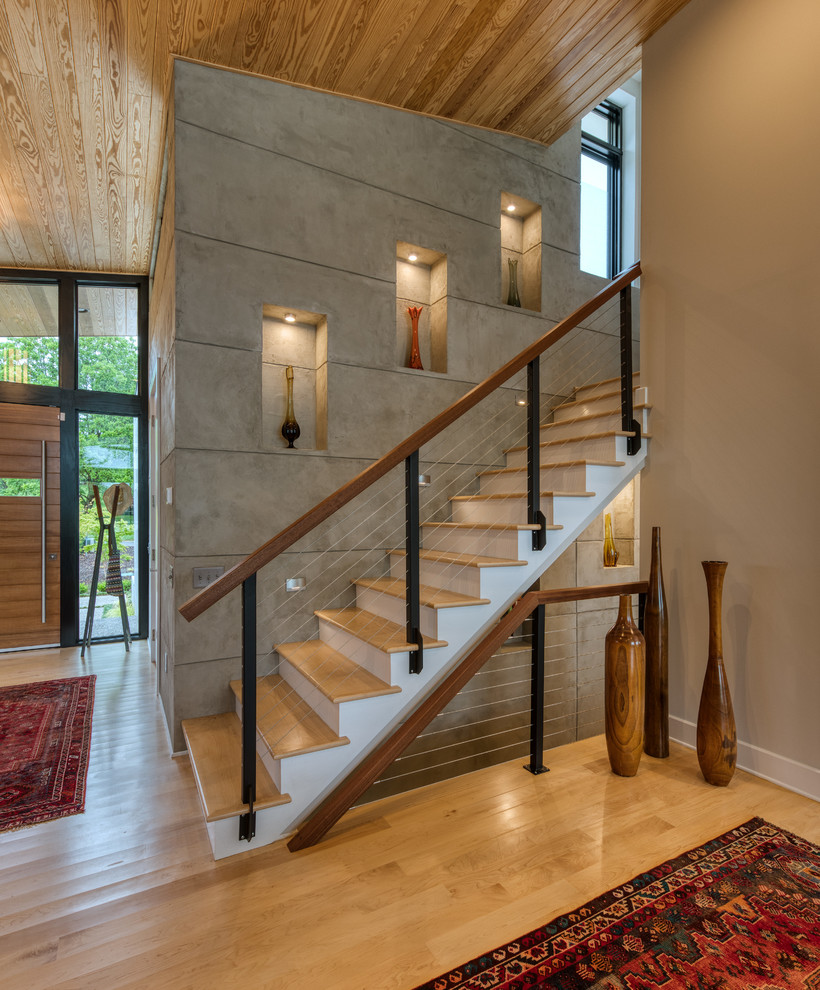 Design ideas for a mid-sized midcentury wood straight staircase in Other with painted wood risers and cable railing.