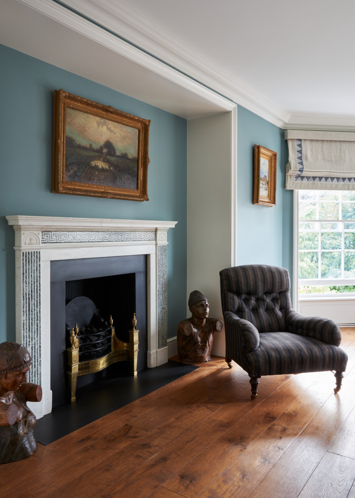 Inspiration for a medium sized traditional master bedroom in London with blue walls, medium hardwood flooring, a standard fireplace, a stone fireplace surround, brown floors, a coffered ceiling and feature lighting.