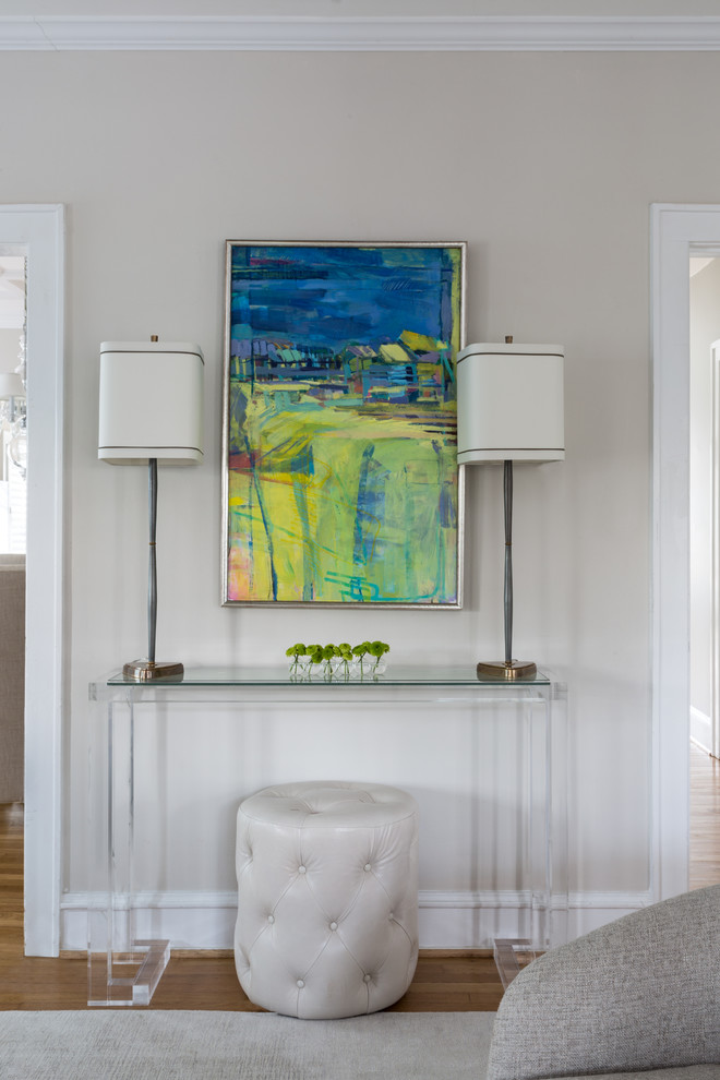 Inspiration for a transitional light wood floor foyer remodel in DC Metro with beige walls and a white front door