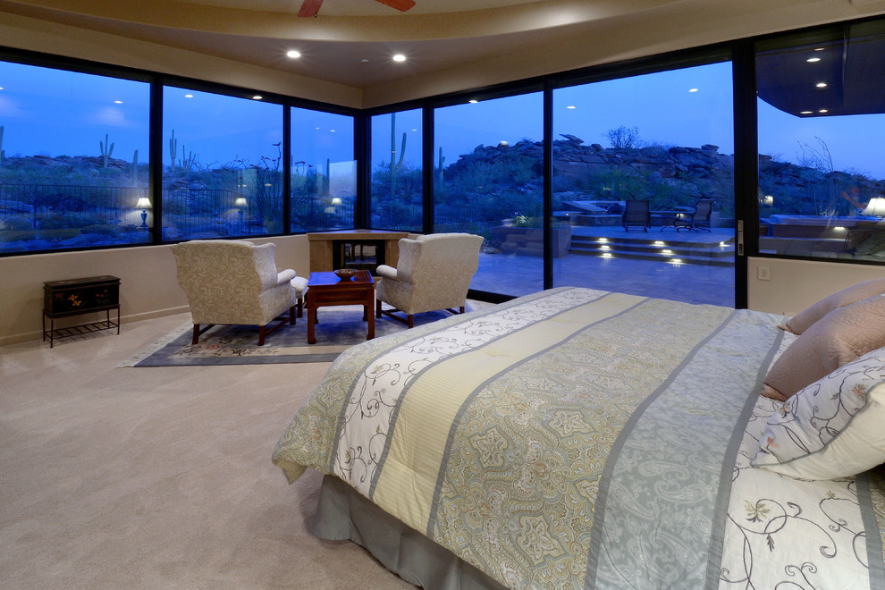 Design ideas for a large transitional master bedroom in Phoenix with beige walls, carpet, a two-sided fireplace and beige floor.