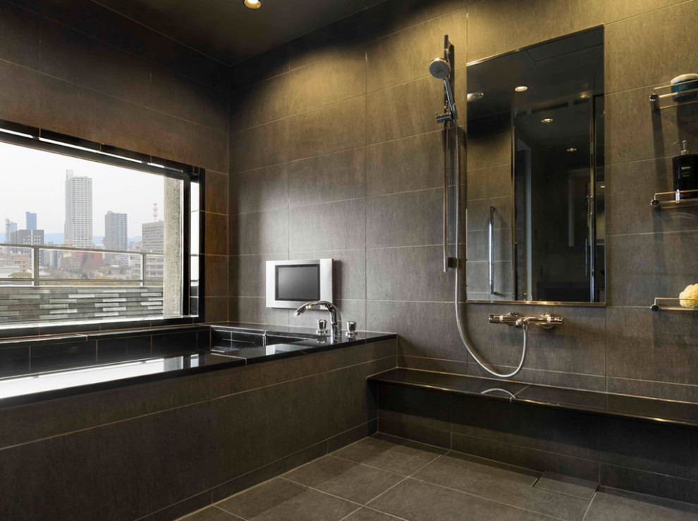 Immagine di una stanza da bagno etnica con vasca idromassaggio, pareti nere, pavimento nero e soffitto ribassato