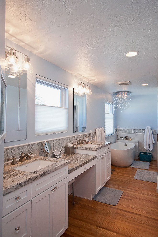 Inspiration for a mid-sized transitional master bathroom in Salt Lake City with an undermount sink, recessed-panel cabinets, white cabinets, granite benchtops, a freestanding tub, a double shower, a two-piece toilet, multi-coloured tile, mosaic tile, blue walls and medium hardwood floors.