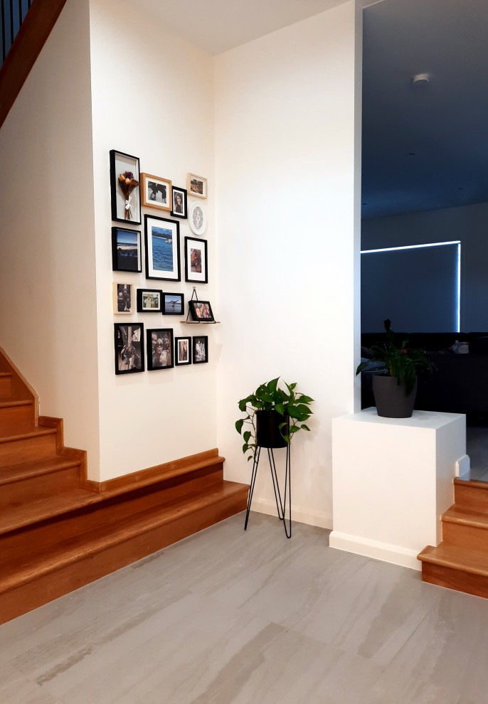 Photo of a large contemporary entry hall in Brisbane with white walls.