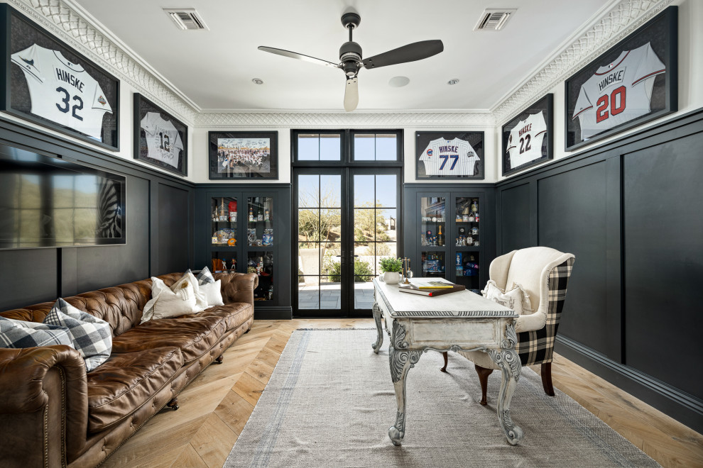 Home office in Phoenix with white walls, medium hardwood floors, a freestanding desk, brown floor and panelled walls.