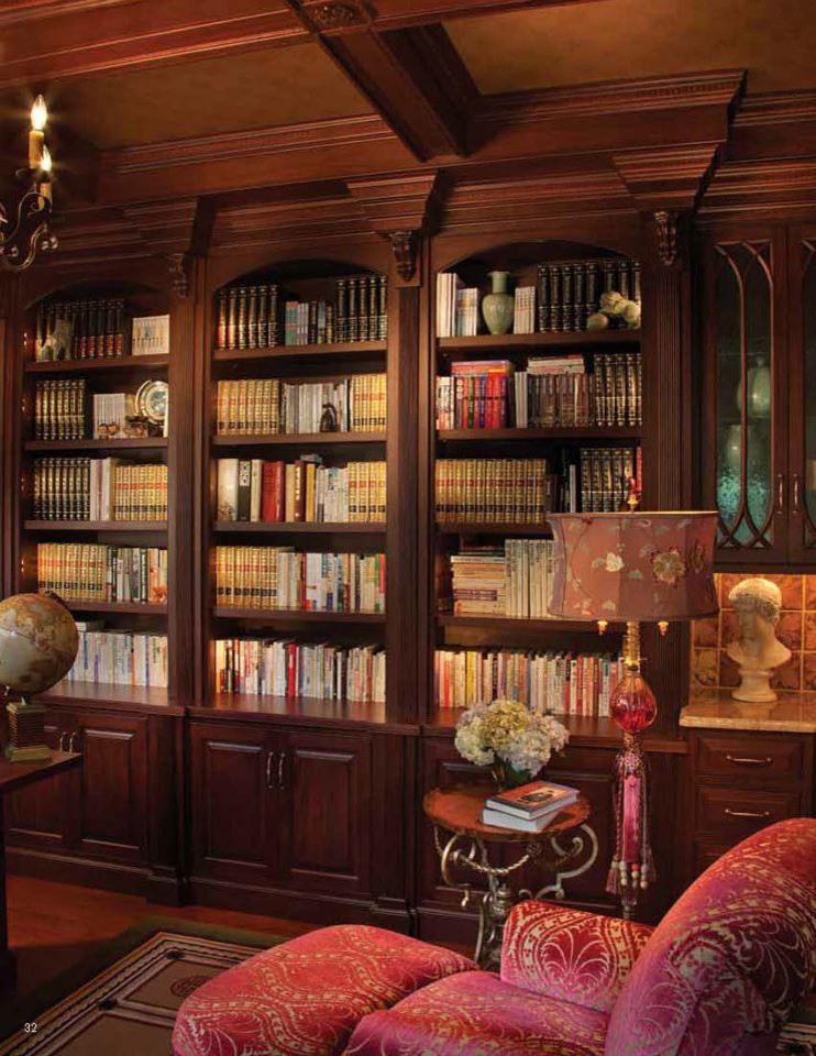 This is an example of a large traditional study room in Philadelphia with a built-in desk, brown walls, dark hardwood floors and no fireplace.