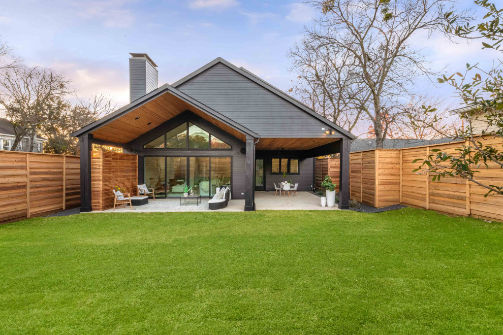 Inspiration for a large and black coastal two floor detached house in Dallas with concrete fibreboard cladding, a pitched roof, a shingle roof, a black roof and shiplap cladding.