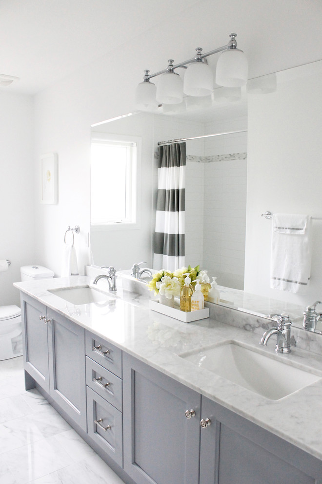 Photo of a traditional bathroom in Toronto with marble benchtops, an undermount sink and grey cabinets.