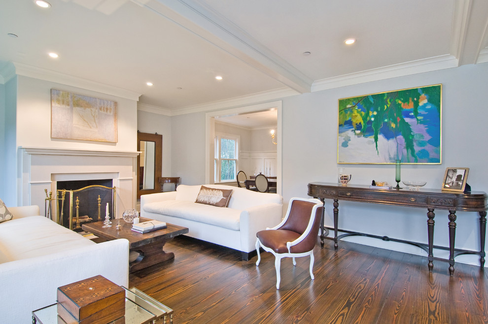 Design ideas for a traditional living room in New York with blue walls, dark hardwood floors and a standard fireplace.