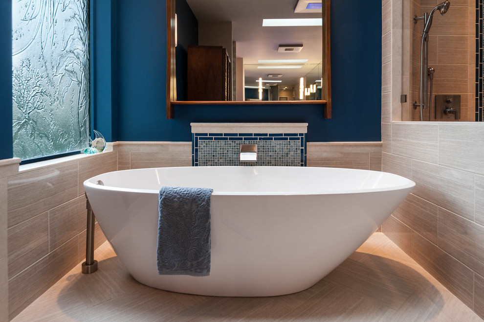 Huge eclectic master multicolored tile and porcelain tile porcelain tile freestanding bathtub photo in Seattle with flat-panel cabinets, beige cabinets, a bidet, beige walls, a vessel sink and glass countertops