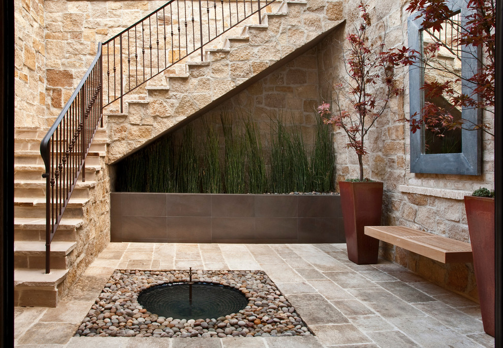 Photo of a mediterranean courtyard patio in Orange County with no cover.