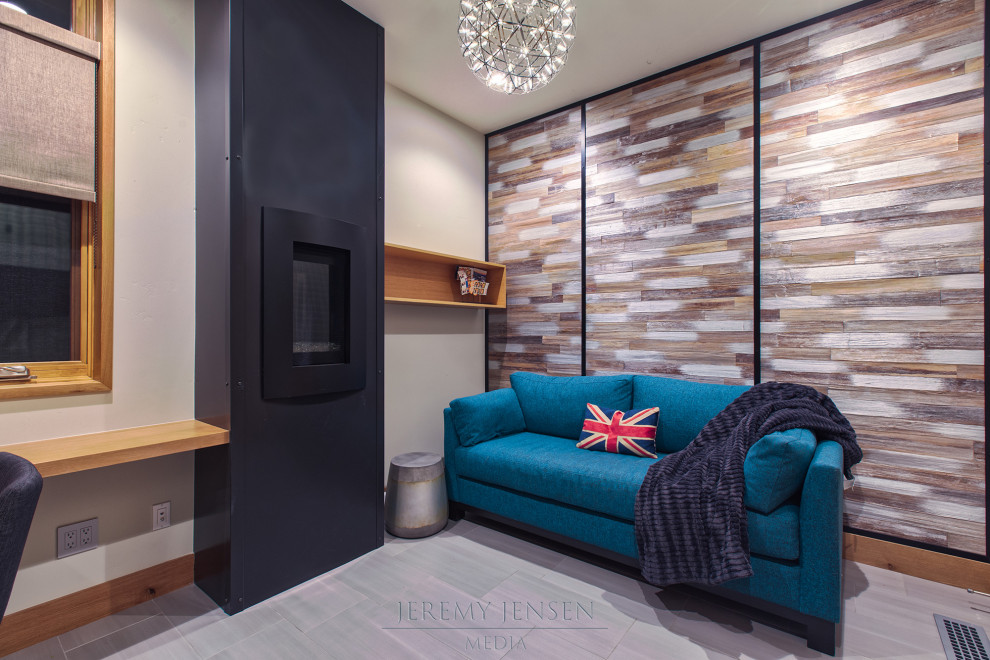 This is an example of a small modern home studio with white walls, porcelain floors, a standard fireplace, a metal fireplace surround, a built-in desk, grey floor and wallpaper.