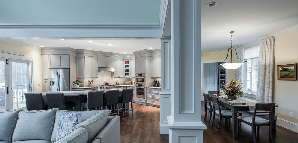 Eat-in kitchen - large transitional single-wall dark wood floor eat-in kitchen idea in Boston with an undermount sink, flat-panel cabinets, gray cabinets, granite countertops, white backsplash, ceramic backsplash, stainless steel appliances and an island