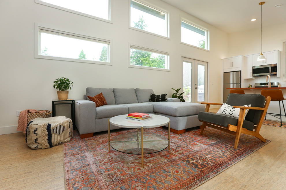 Inspiration for a small scandinavian living room in Seattle with white walls and cork floors.