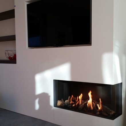 This is an example of a modern family room in Salt Lake City with white walls, a plaster fireplace surround and a wall-mounted tv.