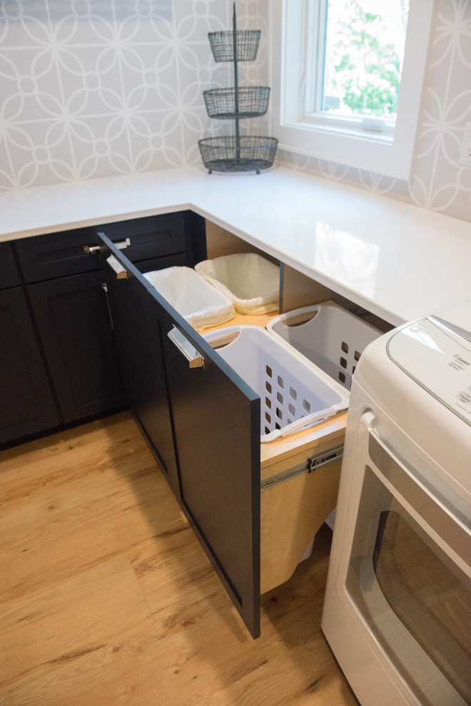 Inspiration for a large transitional u-shaped light wood floor home design remodel with shaker cabinets, blue cabinets, gray walls, a side-by-side washer/dryer and white countertops