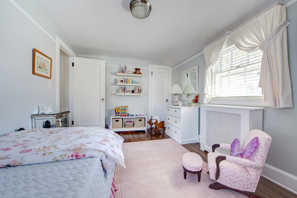 Inspiration for a large traditional kids' room for girls in New York with blue walls and medium hardwood floors.