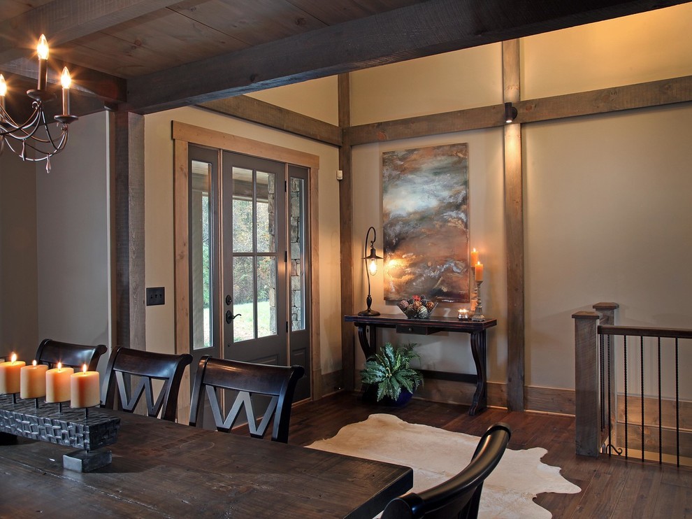 This is an example of a country foyer in Atlanta with beige walls, dark hardwood floors, a single front door and a gray front door.