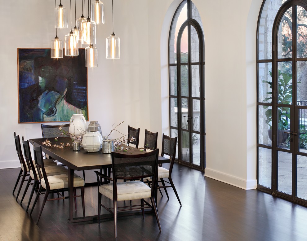 Photo of a contemporary dining room in Austin with white walls and dark hardwood floors.