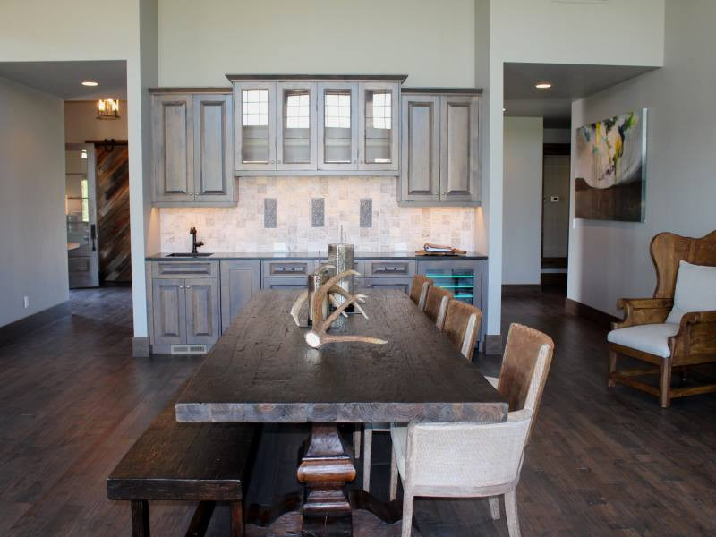 Inspiration for a mid-sized country kitchen/dining combo in Other with white walls, dark hardwood floors, no fireplace and brown floor.