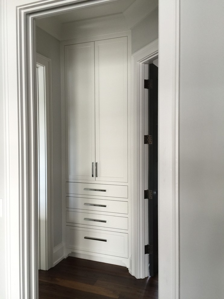 Example of a transitional dark wood floor closet design with gray walls