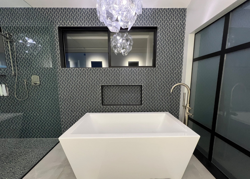 Expansive modern ensuite bathroom in Hawaii with a freestanding bath, a built-in shower, blue tiles, mosaic tiles, porcelain flooring, grey floors, an open shower, a vaulted ceiling and a bidet.