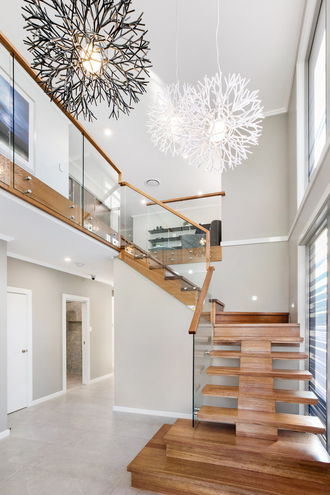 Photo of a contemporary wood l-shaped staircase in Sydney with open risers and mixed railing.