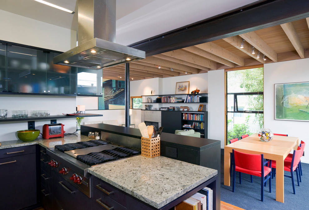 Contemporary u-shaped eat-in kitchen in Seattle with an undermount sink, flat-panel cabinets, black cabinets, granite benchtops, black splashback and stainless steel appliances.