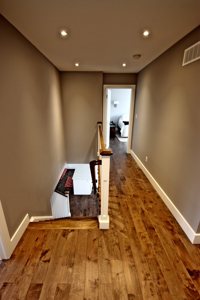 Inspiration for a mid-sized contemporary hallway in Toronto with grey walls and medium hardwood floors.