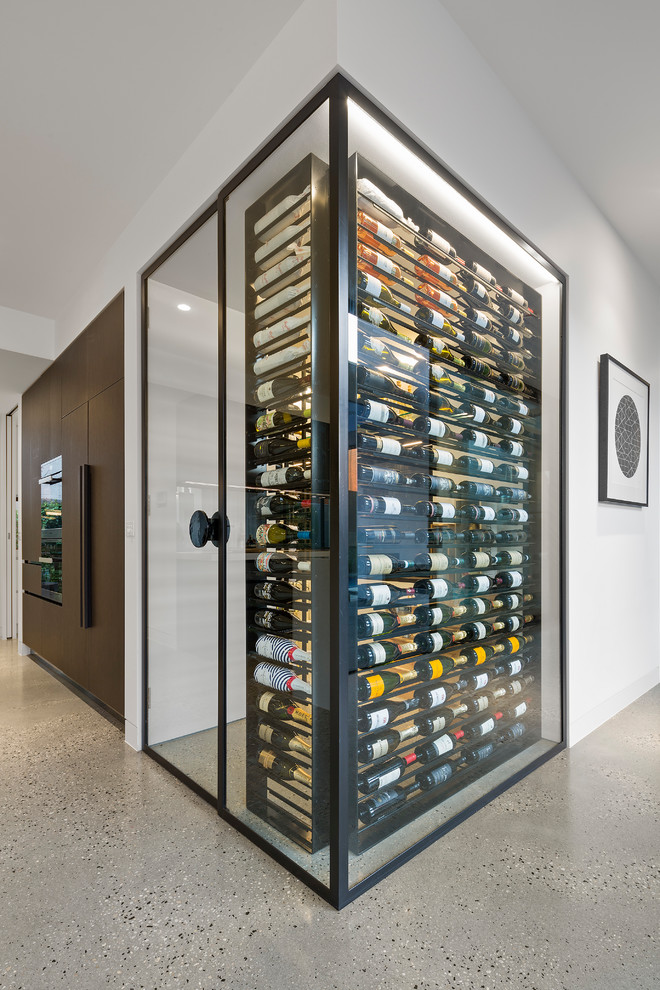 Inspiration for a contemporary wine cellar in Melbourne with concrete floors, display racks and grey floor.