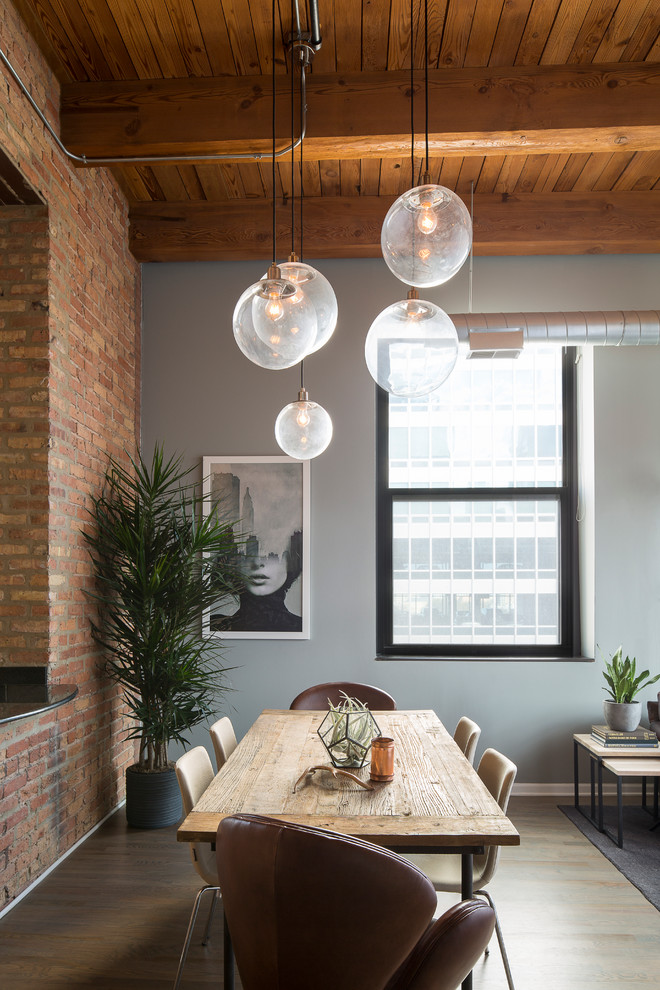 Inspiration for a mid-sized industrial open plan dining in Chicago with grey walls and dark hardwood floors.