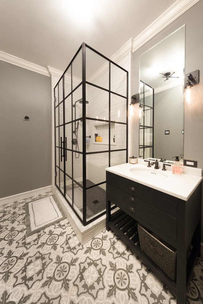 Inspiration for a mid-sized transitional master bathroom in Chicago with flat-panel cabinets, a corner shower, a two-piece toilet, white tile, subway tile, grey walls, terra-cotta floors, an undermount sink, marble benchtops and black cabinets.