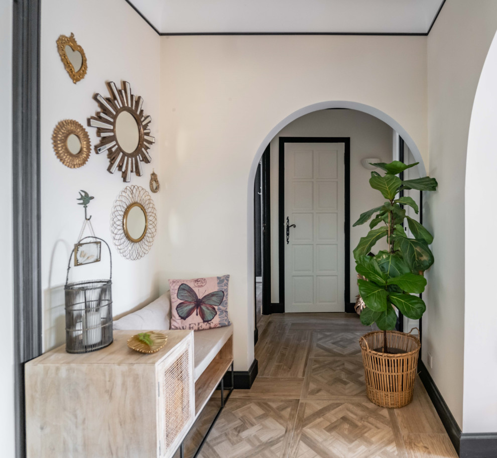 This is an example of a mediterranean foyer in Other with beige walls and a black front door.