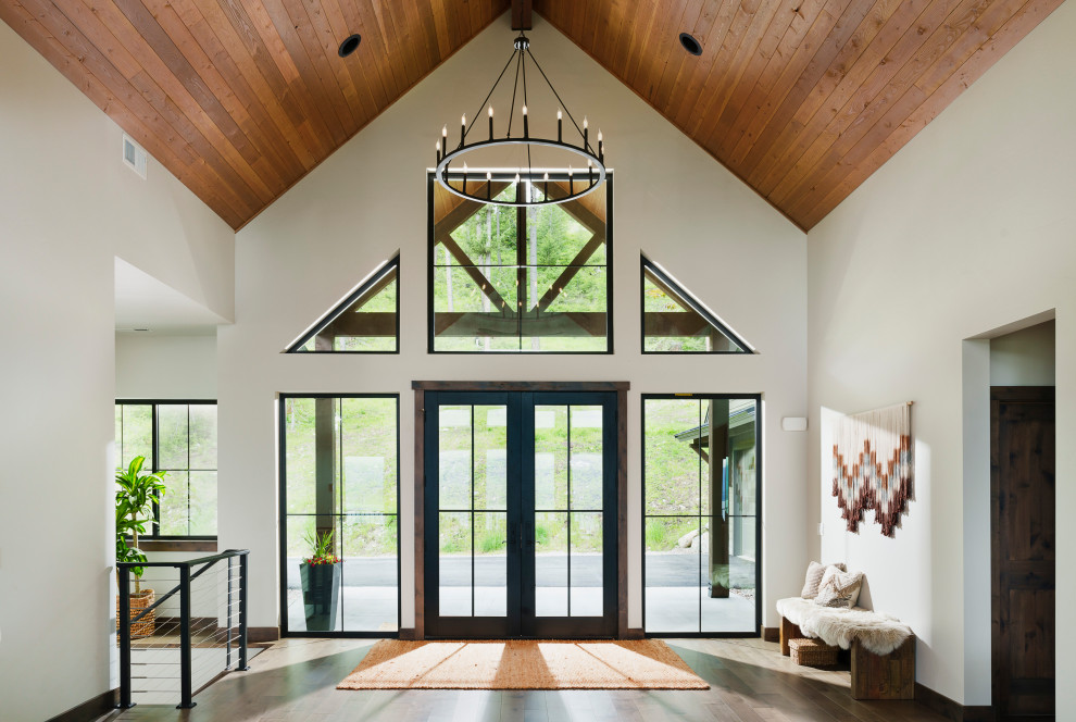Mountain style dark wood floor, brown floor, vaulted ceiling and wood ceiling double front door photo with white walls and a glass front door