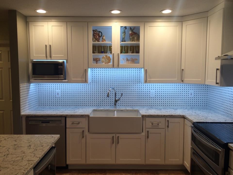 Mid-sized transitional u-shaped ceramic tile and beige floor open concept kitchen photo in Austin with a farmhouse sink, shaker cabinets, white cabinets, granite countertops, multicolored backsplash, porcelain backsplash, stainless steel appliances and an island