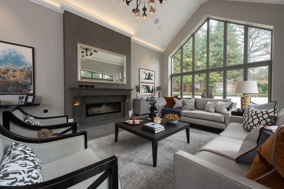 Photo of a mid-sized transitional formal enclosed living room in London with a standard fireplace and a plaster fireplace surround.
