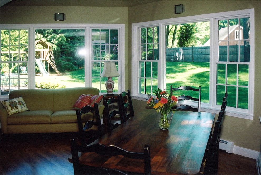 Photo of a traditional sunroom in Boston with medium hardwood floors and a wood stove.
