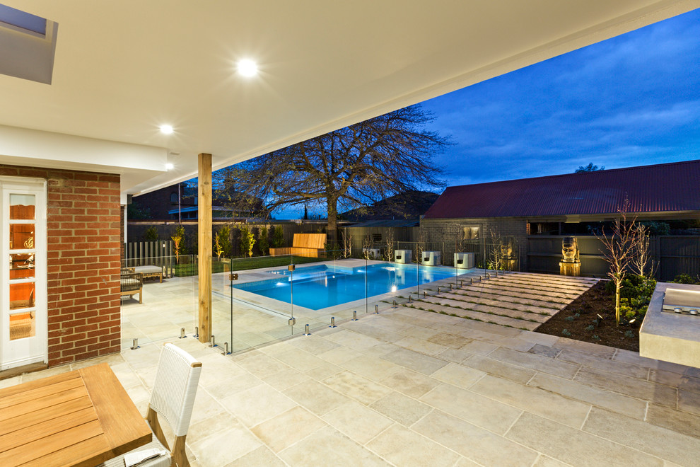 Inspiration for a large contemporary backyard rectangular pool in Melbourne with with a pool and natural stone pavers.