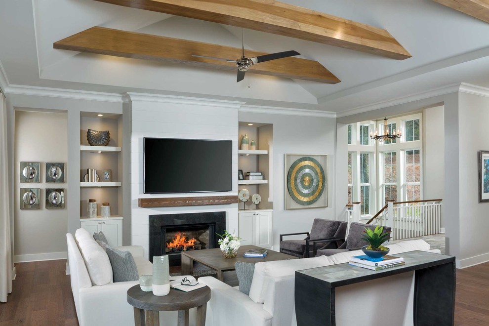 Design ideas for a beach style formal open concept living room in Other with medium hardwood floors, a standard fireplace, a stone fireplace surround and a wall-mounted tv.