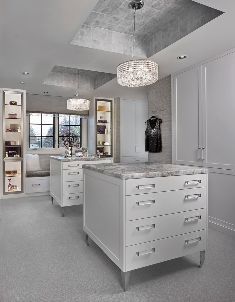 Photo of a transitional women's dressing room in Detroit with white cabinets and carpet.