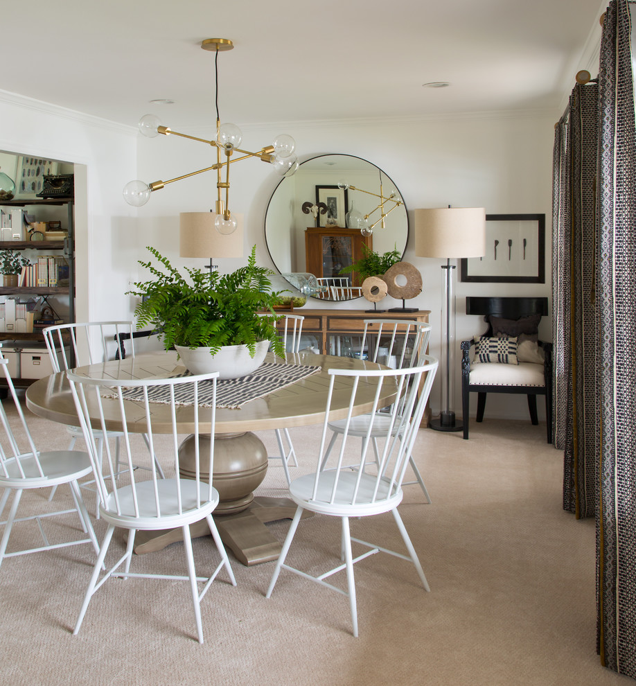 This is an example of an eclectic dining room in Denver with white walls.