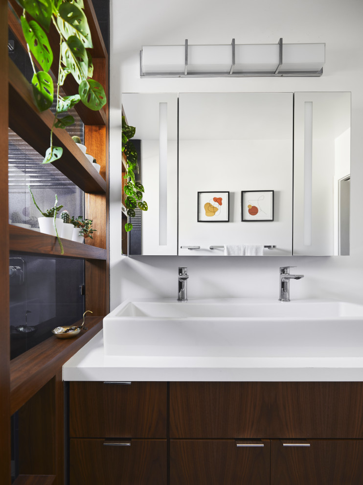 This is an example of a small midcentury master bathroom in Los Angeles with flat-panel cabinets, dark wood cabinets, an alcove shower, a one-piece toilet, black tile, porcelain tile, white walls, porcelain floors, a vessel sink, engineered quartz benchtops, beige floor, a hinged shower door, white benchtops, a niche, a single vanity and a floating vanity.
