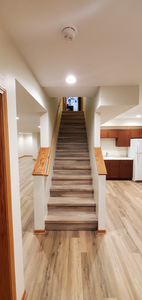 Finished basement vinyl plank floor with matching stairs