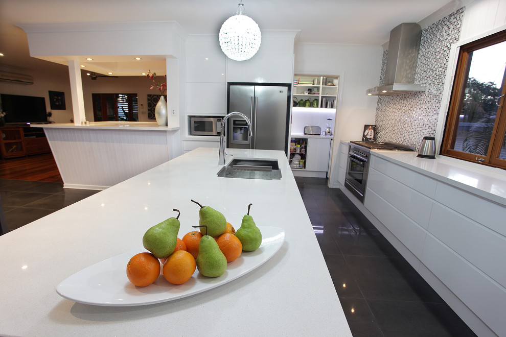 Photo of a large contemporary u-shaped eat-in kitchen in Brisbane with an undermount sink, white cabinets, quartz benchtops, metallic splashback, mosaic tile splashback, stainless steel appliances, porcelain floors and with island.