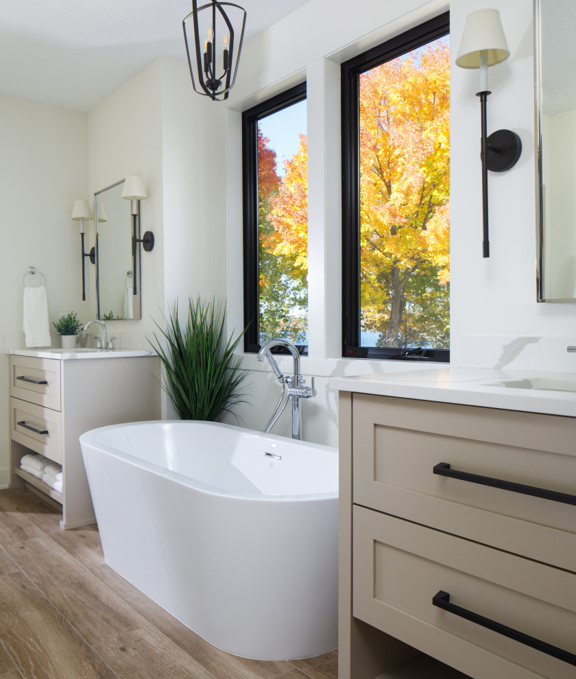 Inspiration for a transitional master bathroom in Minneapolis with shaker cabinets, beige cabinets, a freestanding tub, white walls, wood-look tile, engineered quartz benchtops, brown floor, white benchtops, a double vanity and a built-in vanity.