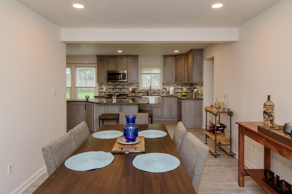 Example of a large transitional u-shaped gray floor eat-in kitchen design in Baltimore with a farmhouse sink, shaker cabinets, gray cabinets, quartz countertops, multicolored backsplash, glass tile backsplash, stainless steel appliances, an island and gray countertops