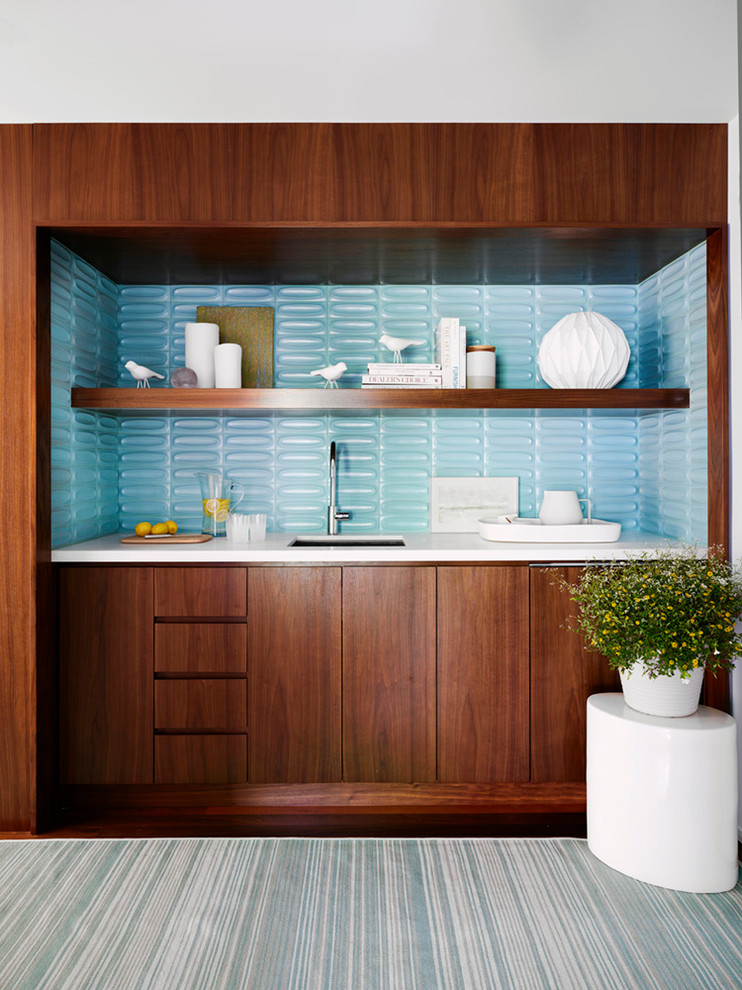 Inspiration for a beach style single-wall wet bar in New York with an undermount sink, flat-panel cabinets, dark wood cabinets, blue splashback, dark hardwood floors, brown floor and white benchtop.