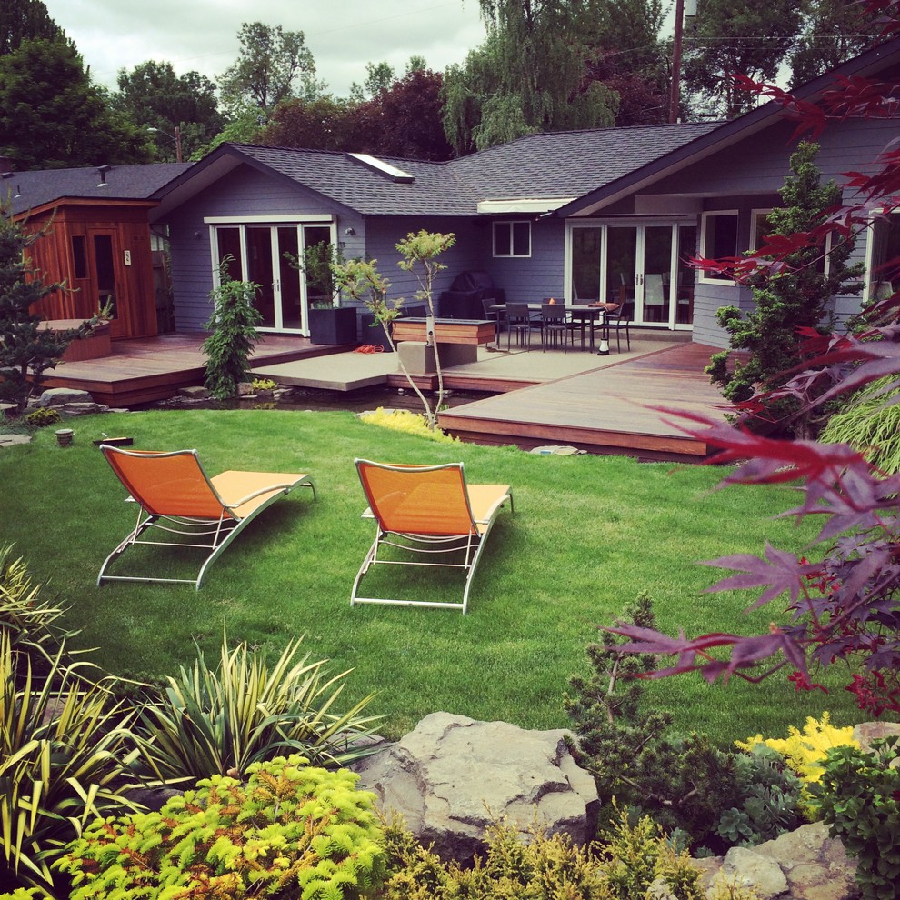 Inspiration for a mid-sized contemporary backyard full sun garden in Other with with pond and decking.