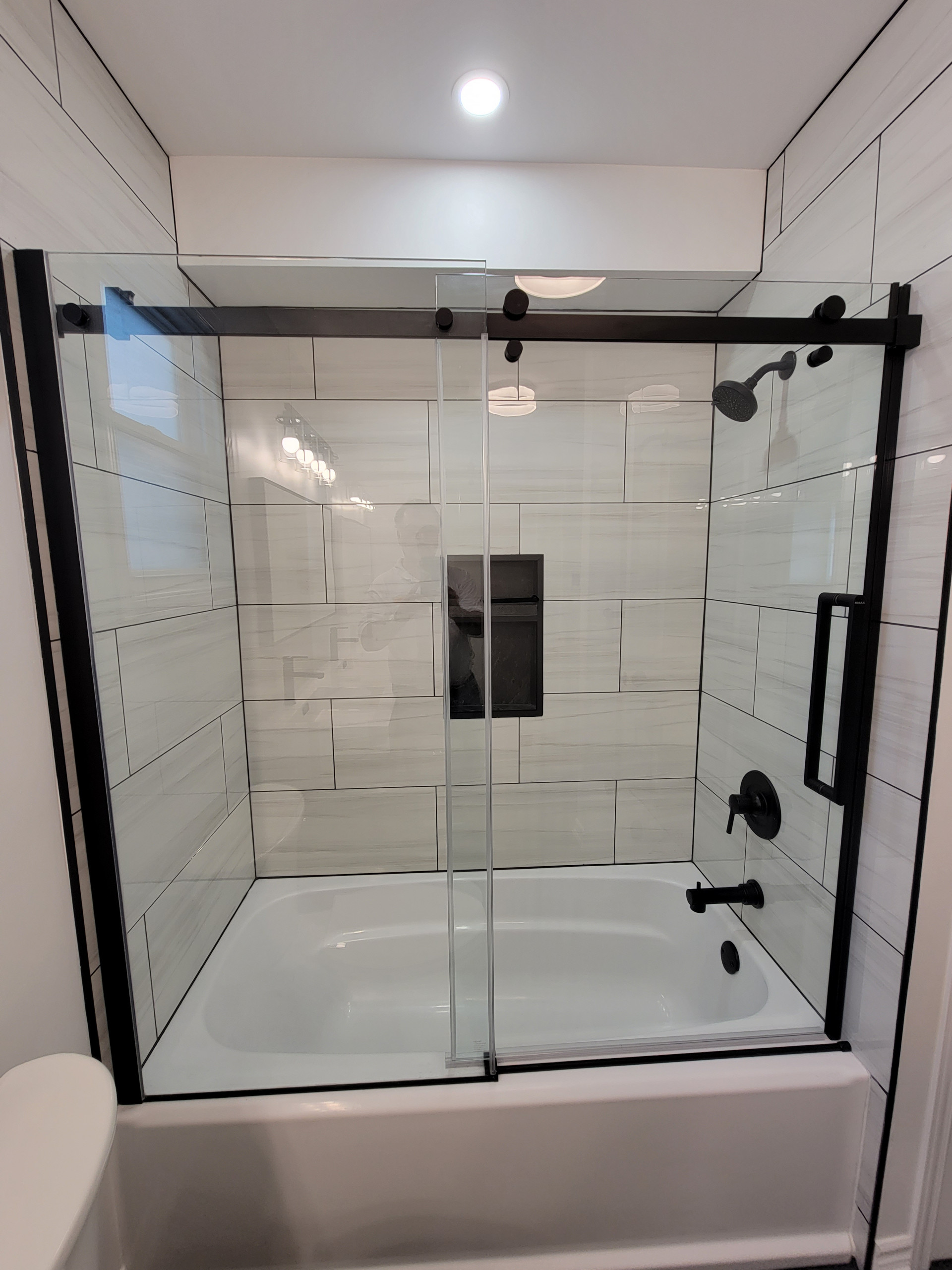 Shower with Large Rectangular Tile and Black Details